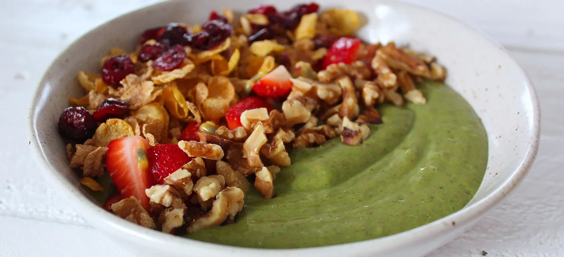 Green Smoothie Bowl with Cereal, Berries, Passionfruit and Toasted Walnuts